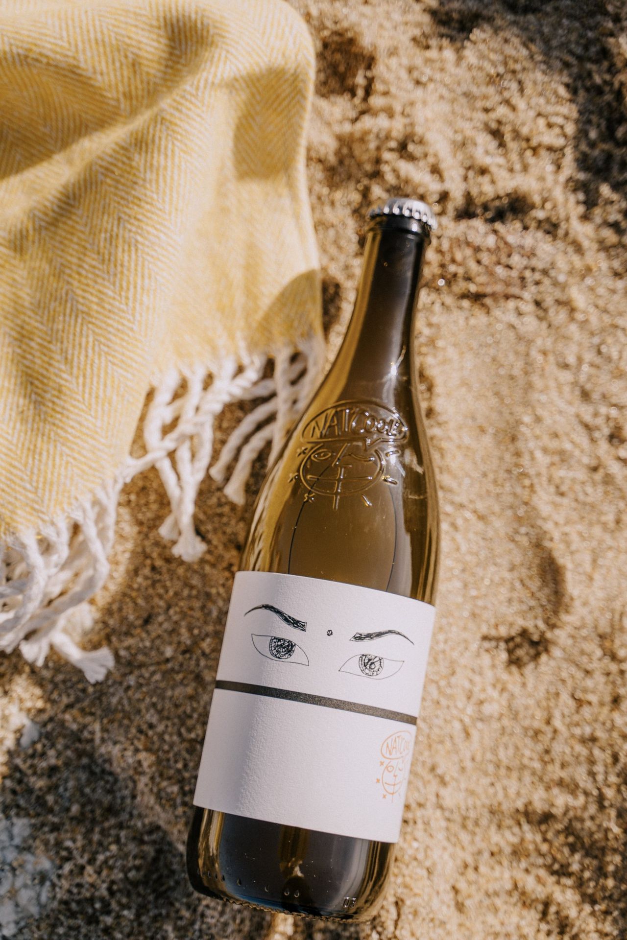 A bottle of Niepoort in the sand